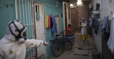 Municipal workers spray insecticide to combat the Aedes aegypti mosquitoes that transmit the Zika virus at the Imbiribeira neighborhood in Recife, Pernambuco state, Brazil, Jan. 26, 2016. (AP Photo)