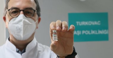 Professor Alper Şener holds a vial of Turkovac COVID-19 vaccine, in Izmir, Turkey, Nov. 22, 2021. (AA Photo)