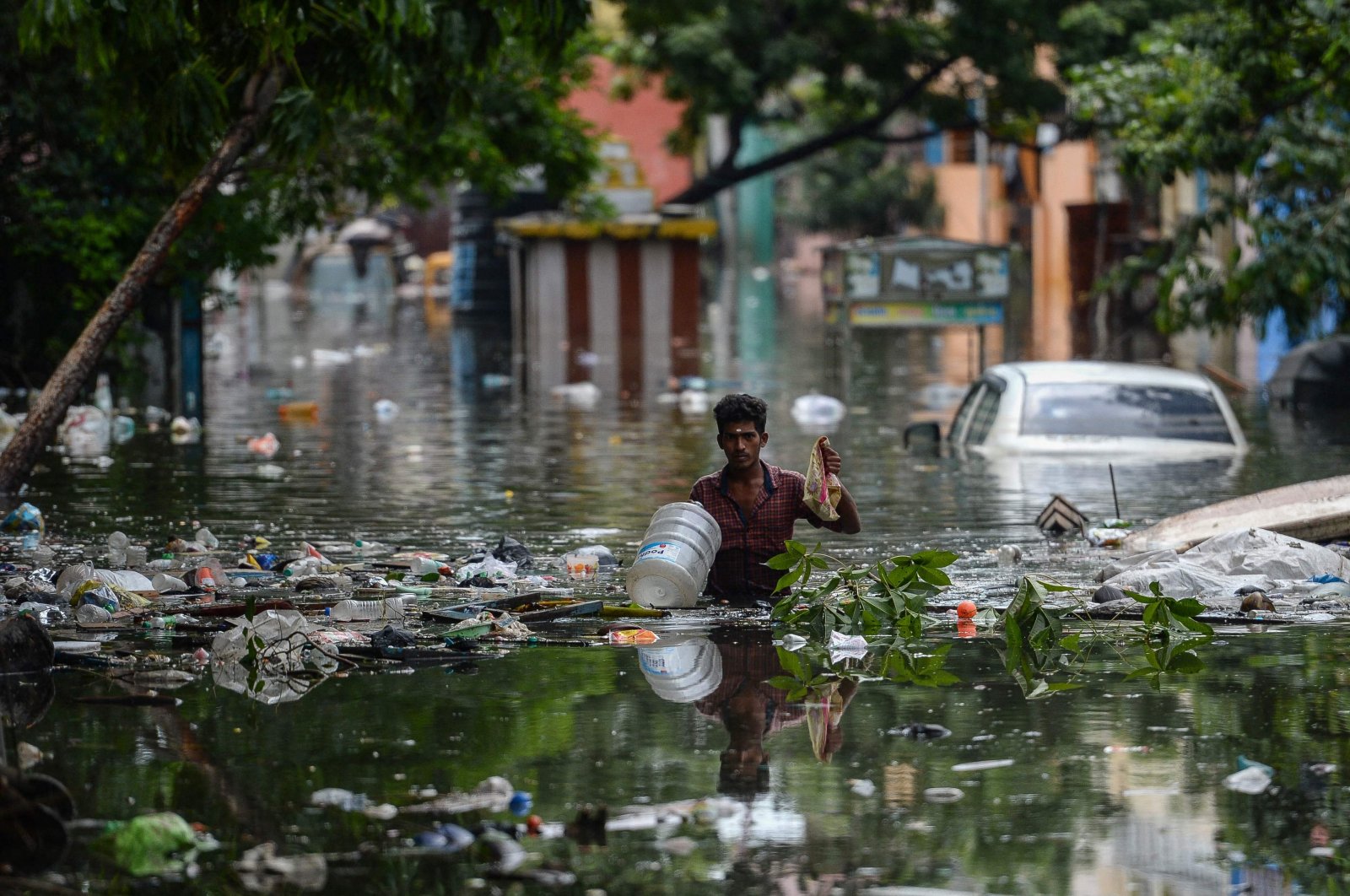 A man wades through a waterlogged street at a residential area after a heavy monsoon rainfall in Chennai, Nov. 12, 2021. (AFP Photo)