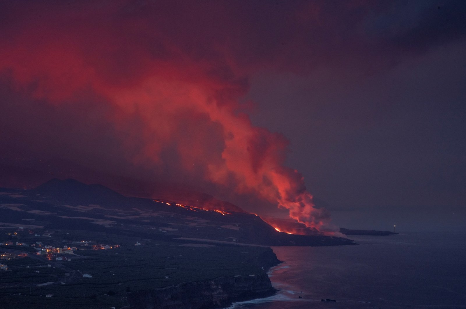 Lava expelled by Cumbre Vieja volcano reaches the sea as seen from Tazacorte in La Palma, Canary Islands, Spain, Nov. 16, 2021.