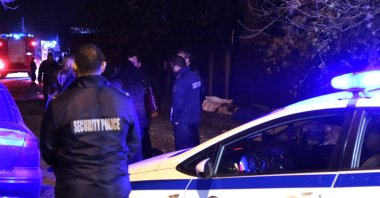 Covered bodies, victims of a fire accident, lie on the ground as police officers and investigators are seen near the nursing home in the village of Royak, Bulgaria, late Monday, Nov. 22, 2021. (Bulphoto Agency via AP)