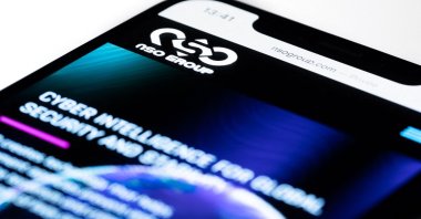 This file studio photo illustration taken on July 21, 2021, shows a smartphone with the website of Israel's NSO Group which features "Pegasus" spyware, on display in Paris. (AFP Photo)