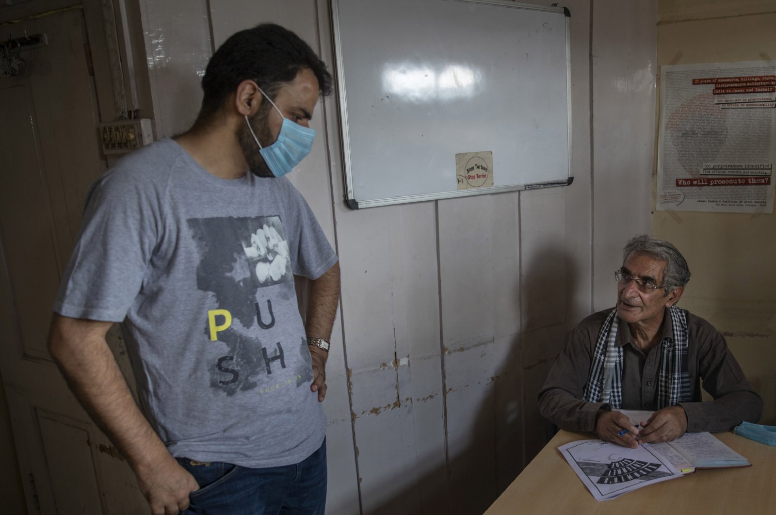 Khurram Parvez, a prominent human rights activist (L) speaks with human rights lawyer Parvez Imroz inside the office of of the Jammu-Kashmir Coalition of Civil Society in Srinagar, Indian-controlled Kashmir, Aug. 25, 2020. (AP File Photo)