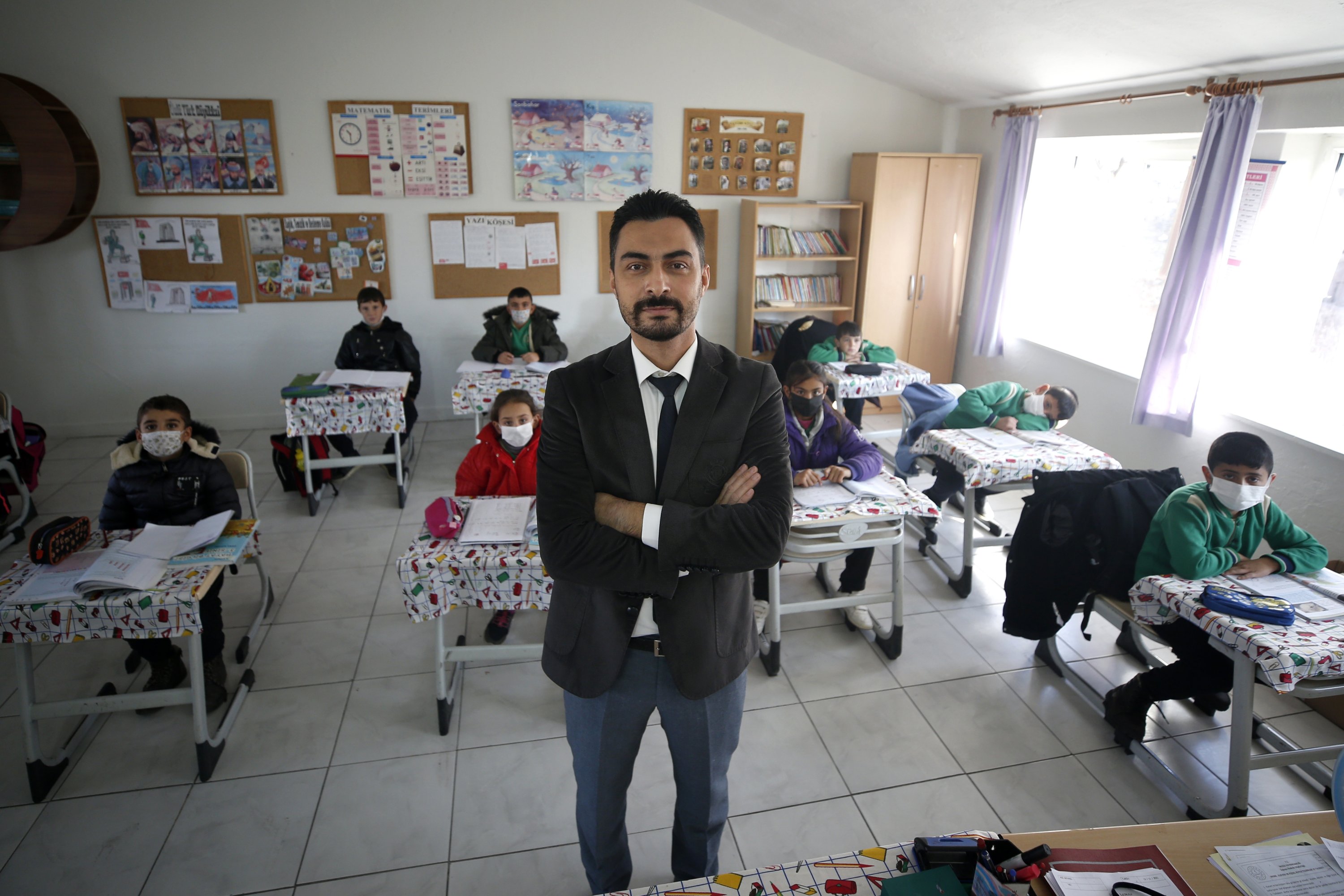 Teacher Harun Dağlı poses for a photo in a depot-turned-classroom, in Kayseri, Turkey, Nov. 23, 2021. (AA Photo)