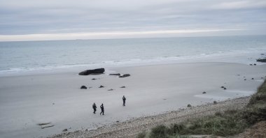 French police officers patrol the beach in search of the migrants in Wimereux, northern France, Nov. 17, 2021. (AP Photo)