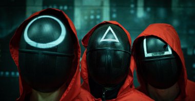 Masked actors pose during an event organized by the Enigma Room escape game, where participants play some of the games inspired from the world-famous South Korean survival television series &quot;Squid Game,&quot; Milan, Italy, Nov. 14, 2021,(AFP File Photo)