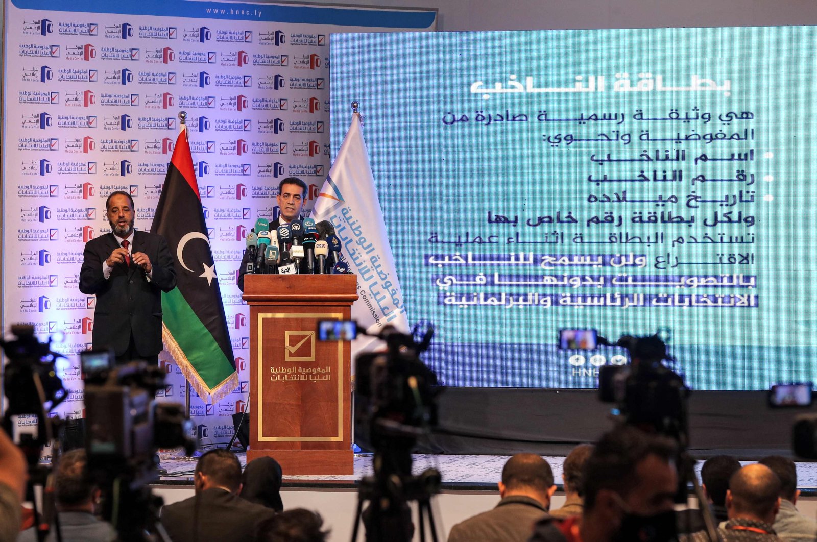 Imad al-Sayeh (R), the head of Libya&#039;s High National Electoral Commission, gives a press conference in the capital Tripoli, Libya, Nov. 23, 2021. (AFP Photo)