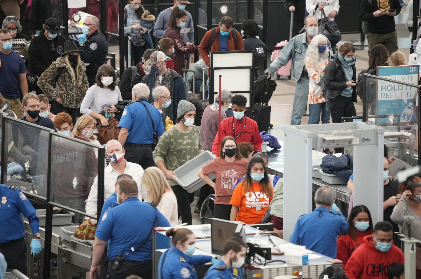 Travelers queue up at the south security checkpoint as traffic increases with the approach of the Thanksgiving Day holiday, Nov. 23, 2021, at Denver International Airport in Denver. (AP Photo)