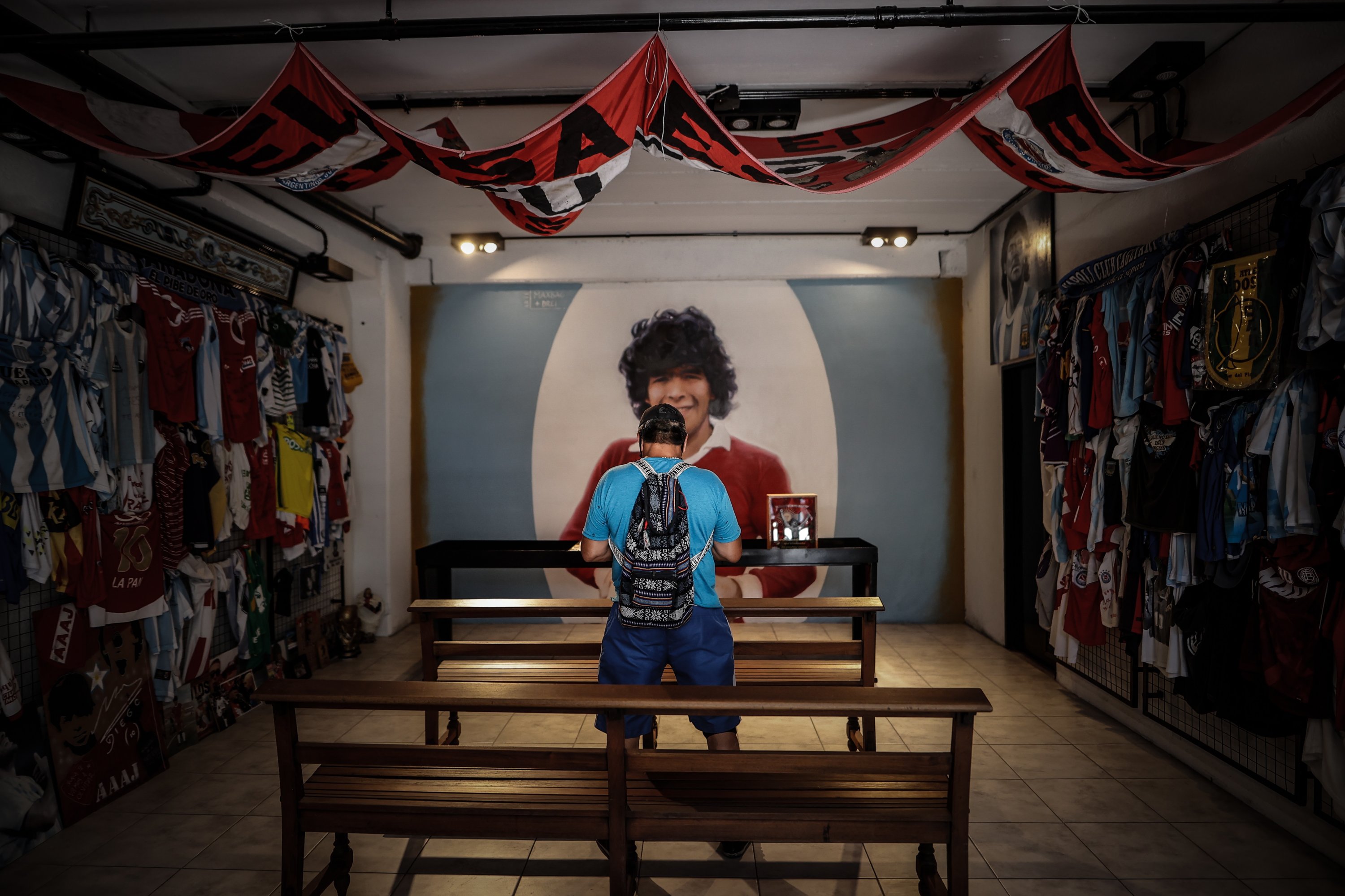 A person prays in a shrine in tribute to the late Argentine footballer Diego Maradona in Buenos Aires, Nov. 23, 2021. (EPA Photo)