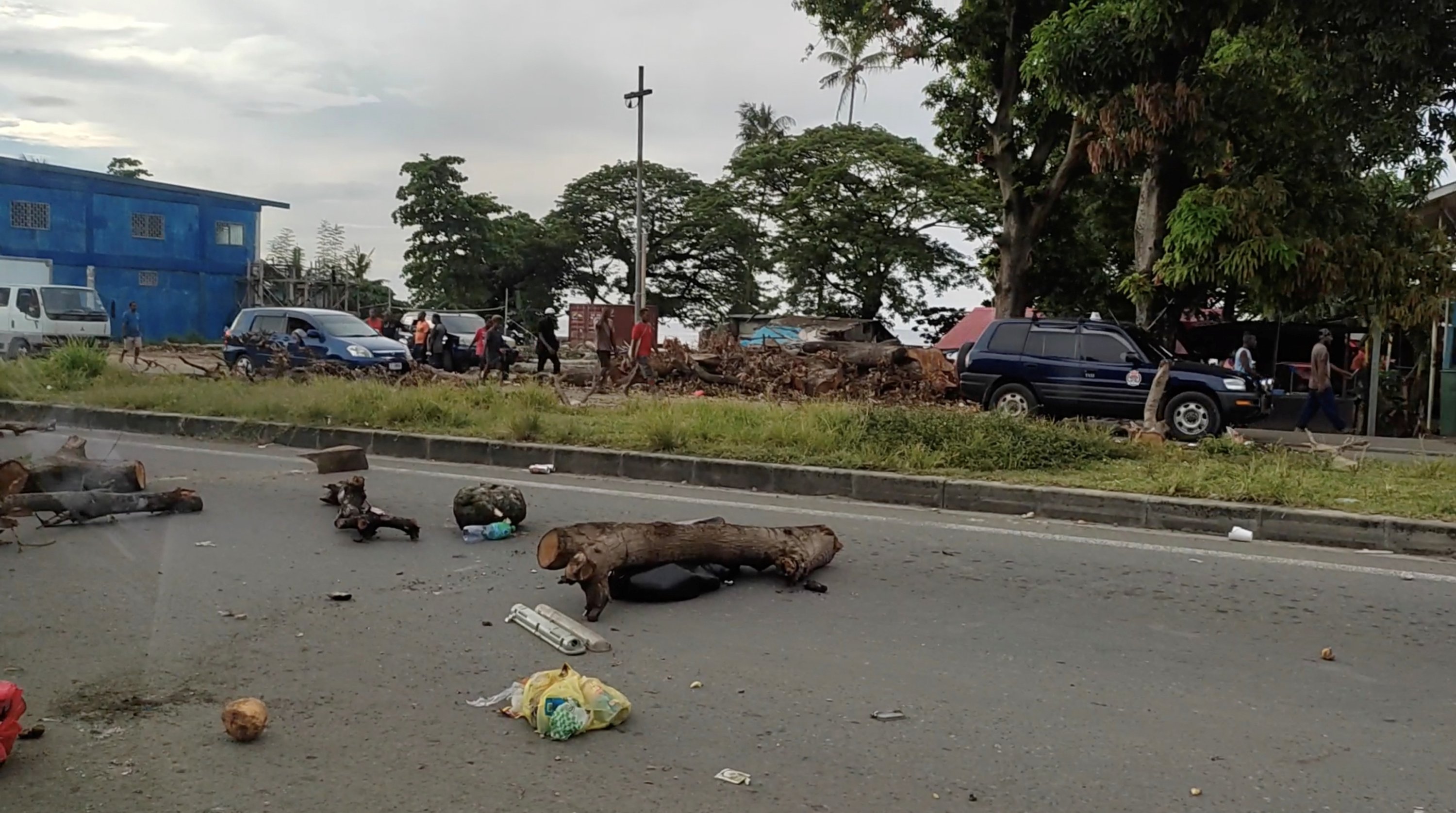 In this screen grab obtained by Reuters from a social media video, debris is seen on a highway, after protests against the government in Honiara, Solomon Islands, Nov. 24, 2021. (Georgina Kekea via Reuters)