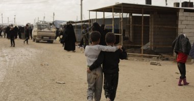Boys from Daesh-held areas walk together in the marketplace at Al-Hol camp, Hassakeh province, Syria, Sunday, March 31, 2019. (AP File Photo)