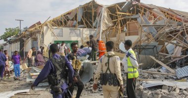 Security forces and rescue workers search for bodies at the scene of a blast in Mogadishu, Somalia, Nov. 25, 2021. (AP Photo)