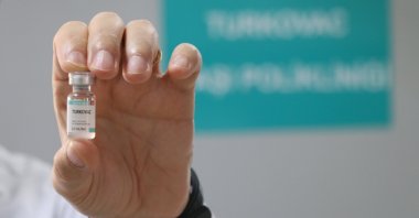 Professor Alper Şener holds a vial of the Turkovac COVID-19 vaccine, Izmir, Turkey, Nov. 22, 2021. (AA Photo)