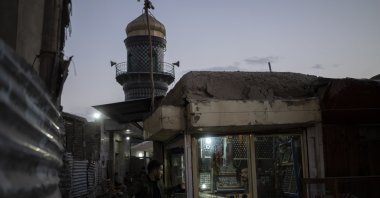 Two men speak to each other in a predominantly Hazara neighborhood in Kabul, Afghanistan, Nov. 9, 2021. (AP Photo)
