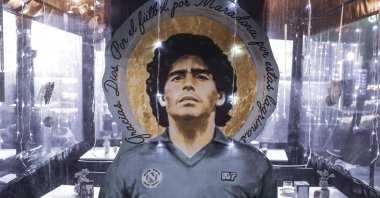 A portrait of Diego Armando Maradona stands out at a restaurant in Naples, Italy, Nov. 24, 2021. (AP Photo)