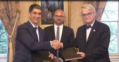 TKYB General Director Ibrahim Öztop (L), French Consul-General in Istanbul Oliver Gauvin (C) and AFD Balkans, Middle East and Asia Director Philippe Orliange shake hands after the Turkey Development and Investment Bank (TKYB) and Agence Francaise de Developpement (AFD) signed a memorandum of understanding, Istanbul, Turkey, Nov. 25, 2021. (IHA PHOTO)
