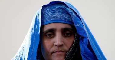 Sharbat Gula, the green-eyed "Afghan Girl" whose 1985 photo in National Geographic became a symbol of her country's wars, arrives to meet with Afghanistan's then President Ashraf Ghani in Kabul, Afghanistan, Nov. 9, 2016. (REUTERS File Photo)