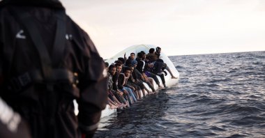 A member of German charity ship Sea-Watch 4's rescue team helps a migrant during a rescue operation in the Mediterranean Sea, Nov. 21, 2021. (Reuters Photo)