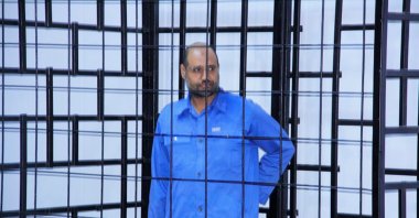 Saif al-Islam Gahdafi, son of late Libyan leader Moammar Gadhafi, attends a hearing behind bars in a courtroom in Zintan, June 22, 2014 . (REUTERS Photo)