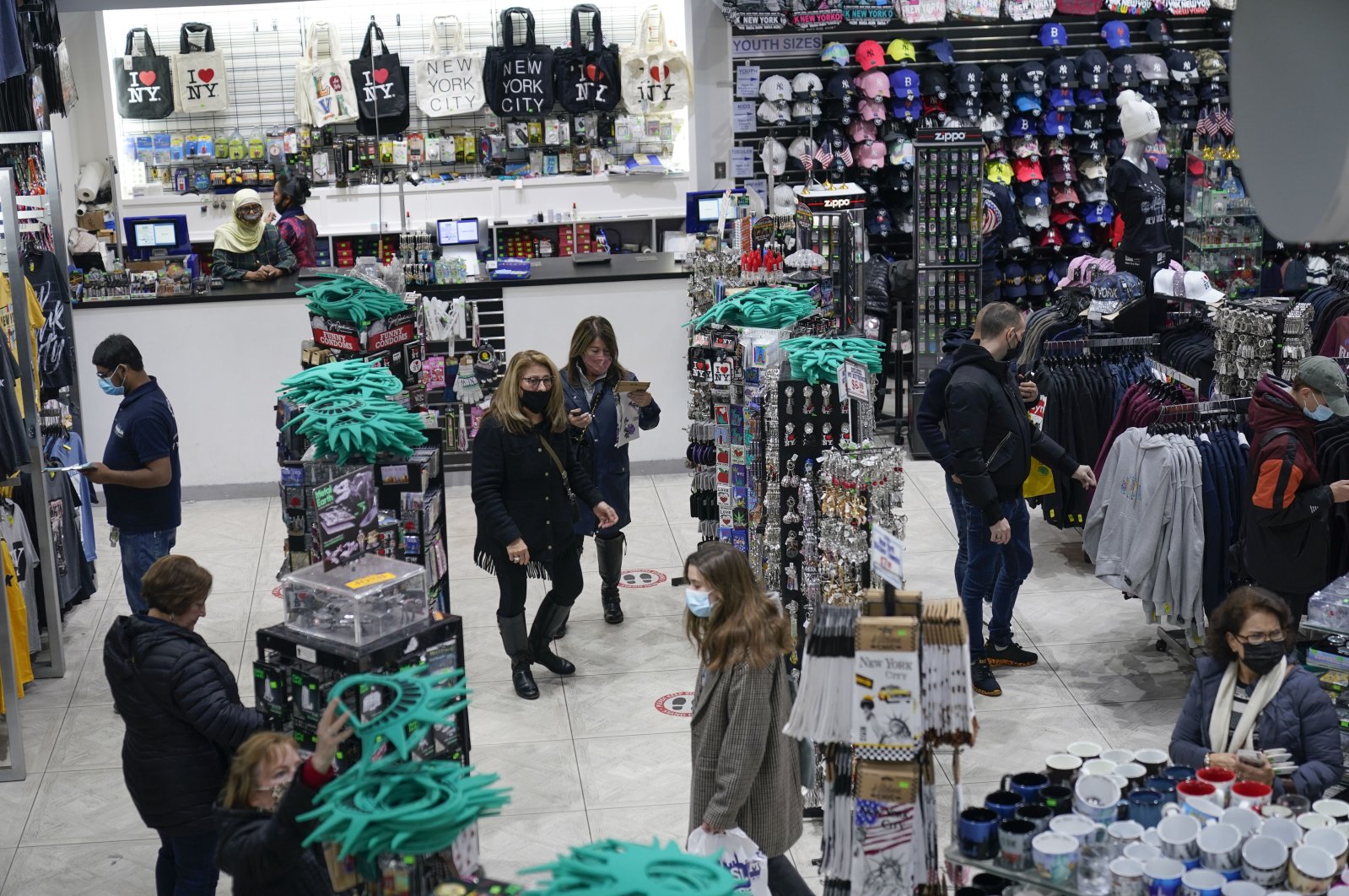 People shop at a souvenir and sports apparel store in Times Square in New York, U.S., Nov. 15, 2021. (AP Photo)