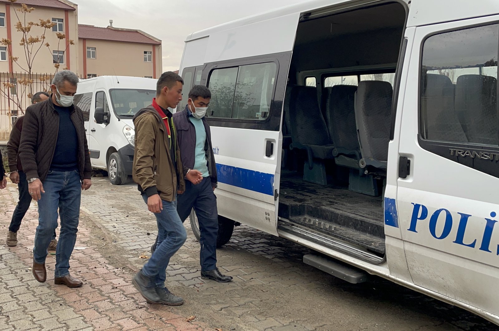 Police escort detained irregular migrants in eastern Erzincan province, Turkey, Nov. 24, 2021.