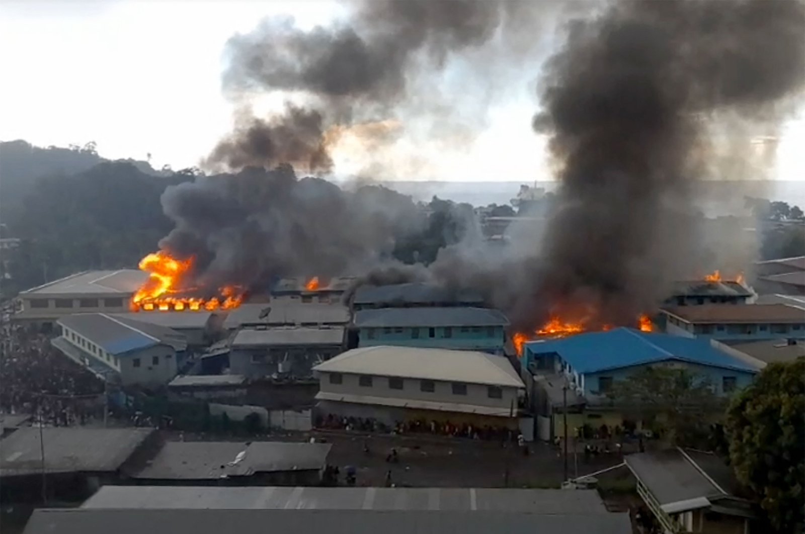 This screengrab taken and received on Nov. 25, 2021, from a video from ZFM Radio shows parts of the Chinatown district on fire in Honiara on Solomon Islands, as rioters torched buildings in the capital in the second day of anti-government protests, Solomon Islands. (JOB RONGO&#039;AU FUOO / ZFM Radio / AFP)