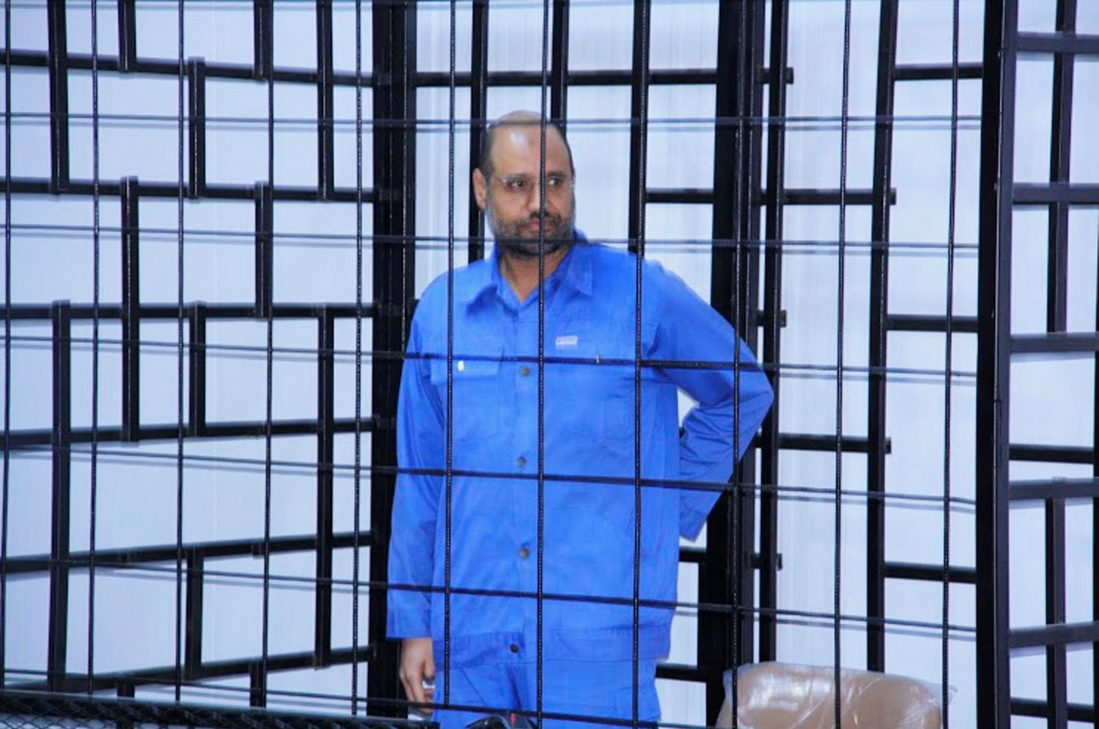 Saif al-Islam Gahdafi, son of late Libyan leader Moammar Gadhafi, attends a hearing behind bars in a courtroom in Zintan, June 22, 2014 . (REUTERS Photo)