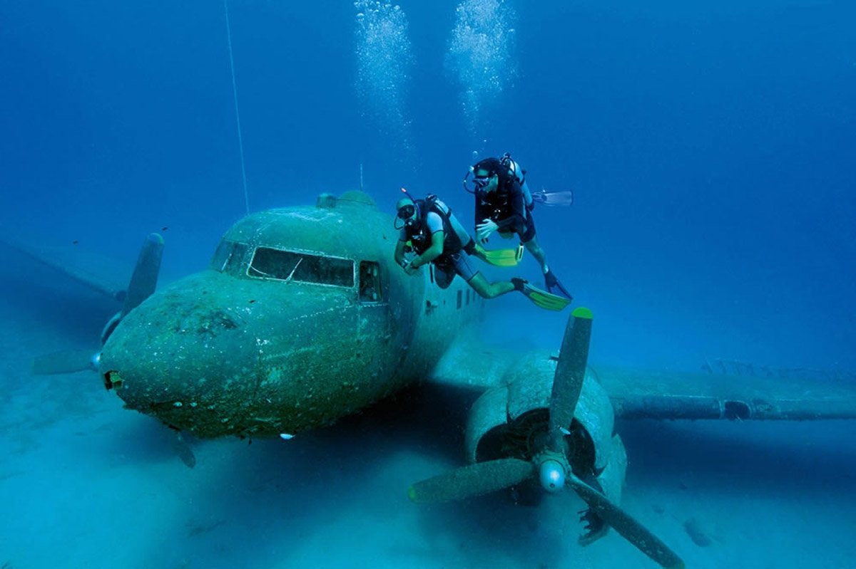 Divers explore the Dakota C-47 aircraft, which was donated to the Kaş Underwater Association by the Turkısh Air Force and sunken in 2009 for diving tourism