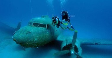 Divers explore the Dakota C-47 aircraft, which was donated to the Kaş Underwater Association by the Turkısh Air Force and sunken in 2009 for diving tourism, Kaş, Turkey. (Sabah File Photo) 