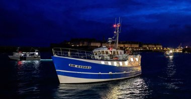 French fishing boats block the entrance to the port of Saint-Malo on Nov. 26, 2021 as fishermen planned to block ferry traffic into two other Channel ports and the movement of goods through the rail tunnel between France and the U.K. in protest over post-Brexit fishing rights. (AFP Photo)
