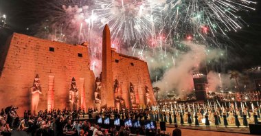 Fireworks light the sky during the official ceremony opening the 'Rams Road' outside the pylon and remaining obelisk at the entrance of the Temple of Luxor (built around 1400 B.C.) in Egypt's southern city of the same name on Nov. 25, 2021. (AFP Photo)