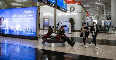 Passengers wearing protective masks wait for flights at the Istanbul Airport, in Istanbul, Turkey, June 1, 2020. (AFP File Photo)