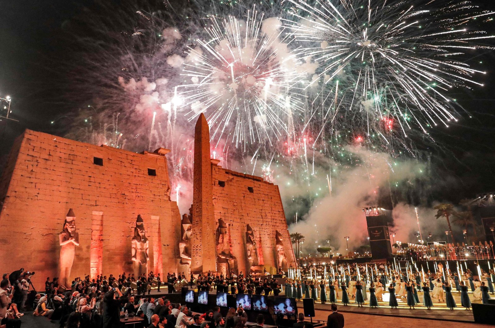 Fireworks light the sky during the official ceremony opening the 'Rams Road' outside the pylon and remaining obelisk at the entrance of the Temple of Luxor (built around 1400 B.C.) in Egypt's southern city of the same name on Nov. 25, 2021. (AFP Photo)