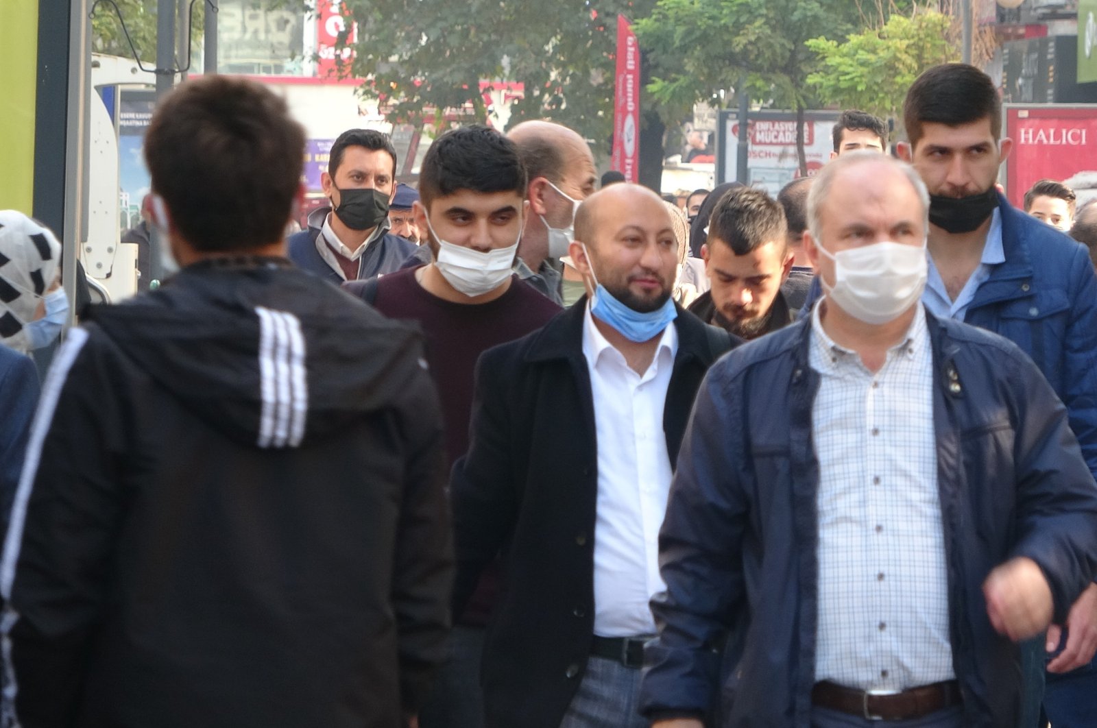 People wearing protective masks against COVID-19 walk on a street, in Karabük, northern Turkey, Nov. 21, 2021. (İHA PHOTO) 