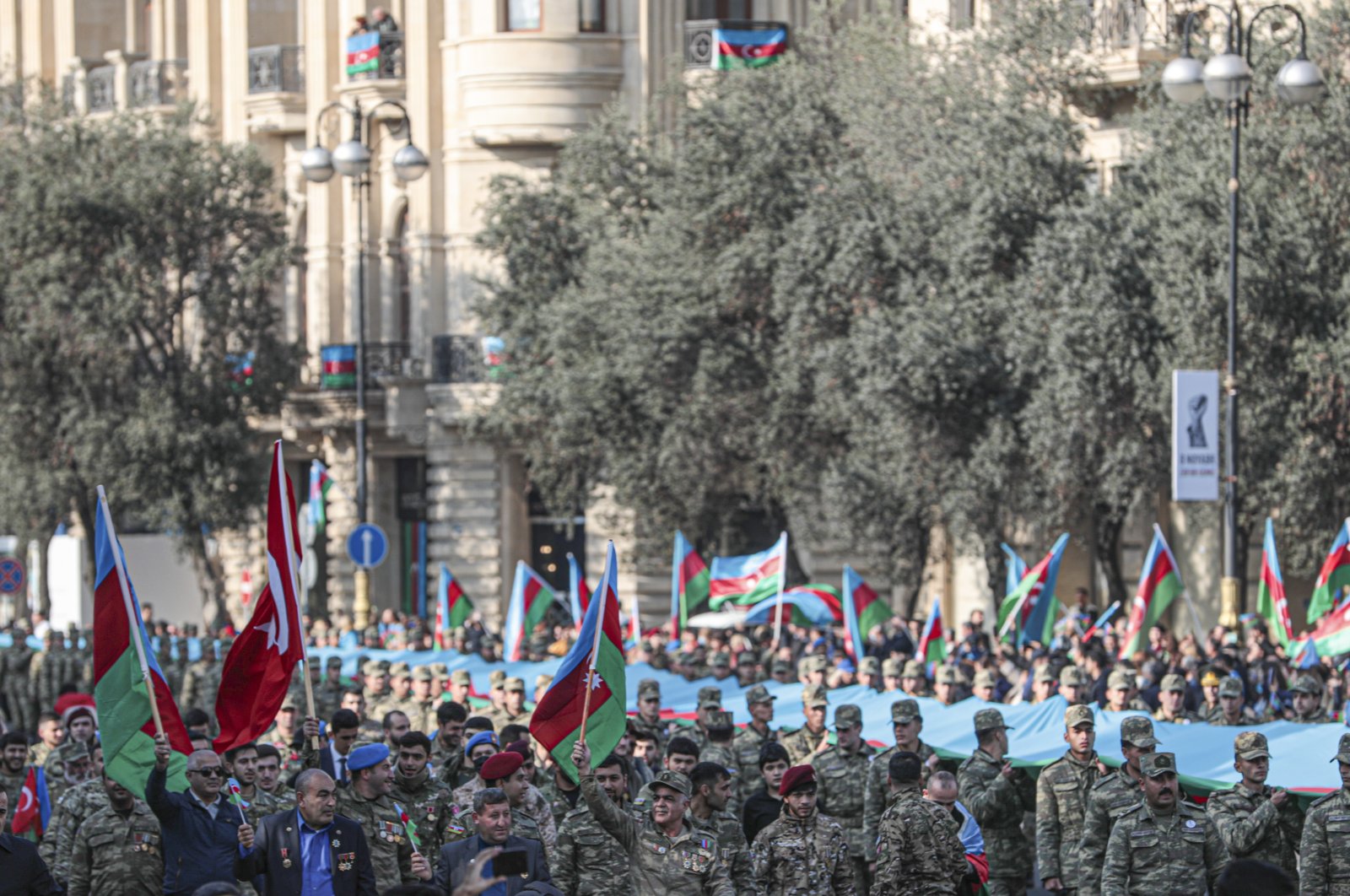 Azerbaijani soldiers carry a large-scale national flag on the anniversary of the end of the 2020 war over the Nagorno-Karabakh region between Azerbaijan and Armenia, in downtown Baku, Azerbaijan, 08 November 2021. (EPA Photo)
