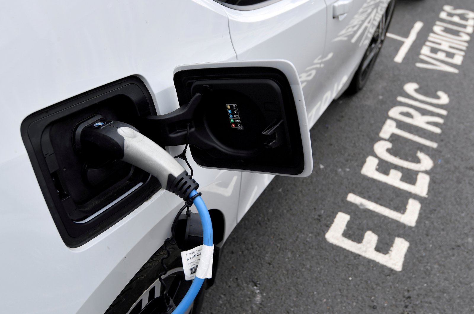 An electric car is being charged at a roadside EV charge point, London, Britain, Oct. 19, 2021. (Reuters Photo)