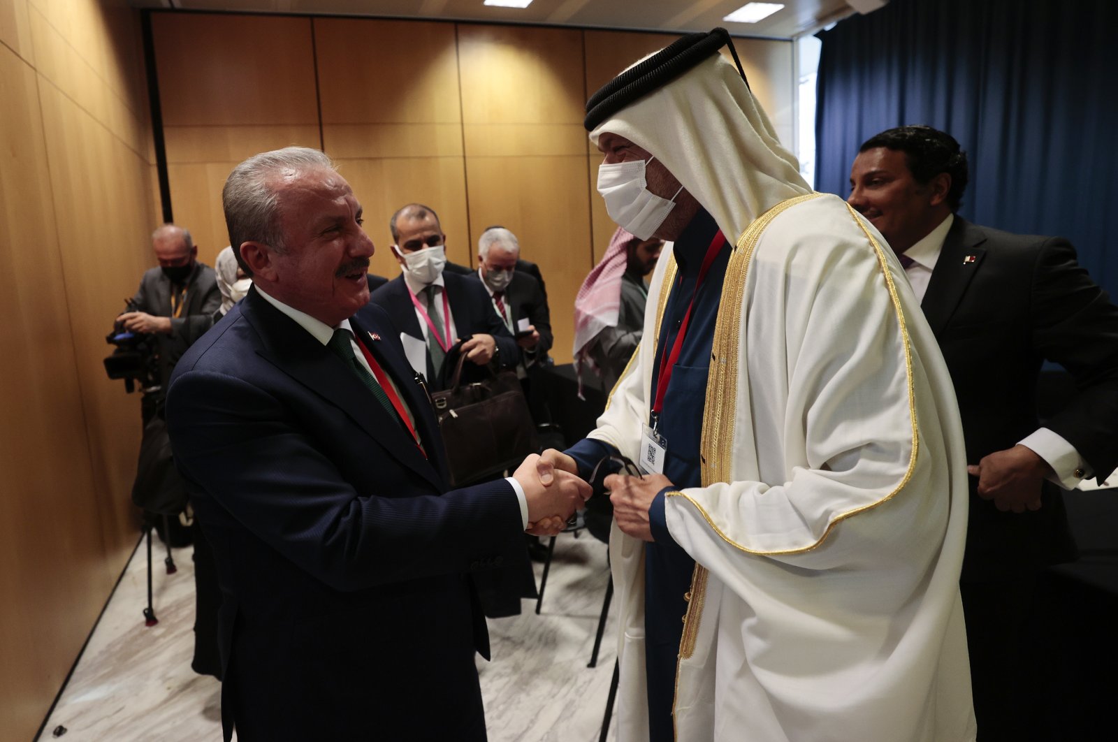 Parliament Speaker Mustafa Şentop and Qatar’s Shura Council Speaker Hassan bin Abdullah Al-Ghanim (R) shake hands at the 143rd Inter-Parliamentary Union Assembly, Madrid, Spain, Nov. 26, 2021. (AA Photo)