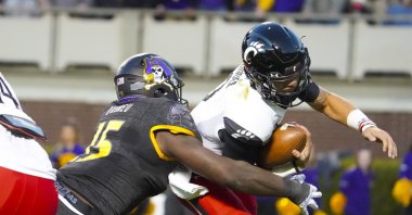 East Carolina Pirates defensive lineman Rick D&#039;Abreu (15) sacks Cincinnati Bearcats quarterback Desmond Ridder (9) during the first half at Dowdy-Ficklen Stadium, Greenville, North Carolina, U.S., Nov. 26, 2021. (James Guillory-USA TODAY Sports via Reuters)