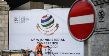 A worker removes fences next to the entrance of the World Trade Organization (WTO) headquarters after next week&#039;s WTO ministerial conference, the global trade body&#039;s biggest gathering in four years, was postponed at the last minute due to the new omicron COVID-19 variant, Geneva, Switzerland, Nov. 27, 2021.  (AFP Photo)