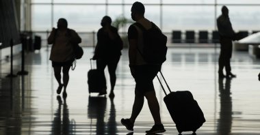 Travelers move through Salt Lake City International Airport, Salt Lake City, Utah, U.S., Aug. 17, 2021. (AP Photo)