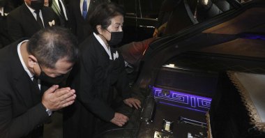Lee Soon-ja, (2R), the wife of the late former South Korean President Chun Doo-hwan, watches the coffin containing the body of her husband at a funeral hall in Seoul, South Korea, Saturday, Nov. 27, 2021. (AP Photo)