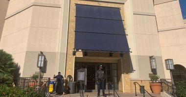 A security guard stands outside the Nordstrom store at The Grove retail and entertainment complex in Los Angeles, Tuesday, Nov. 23, 2021. (AP Photo)