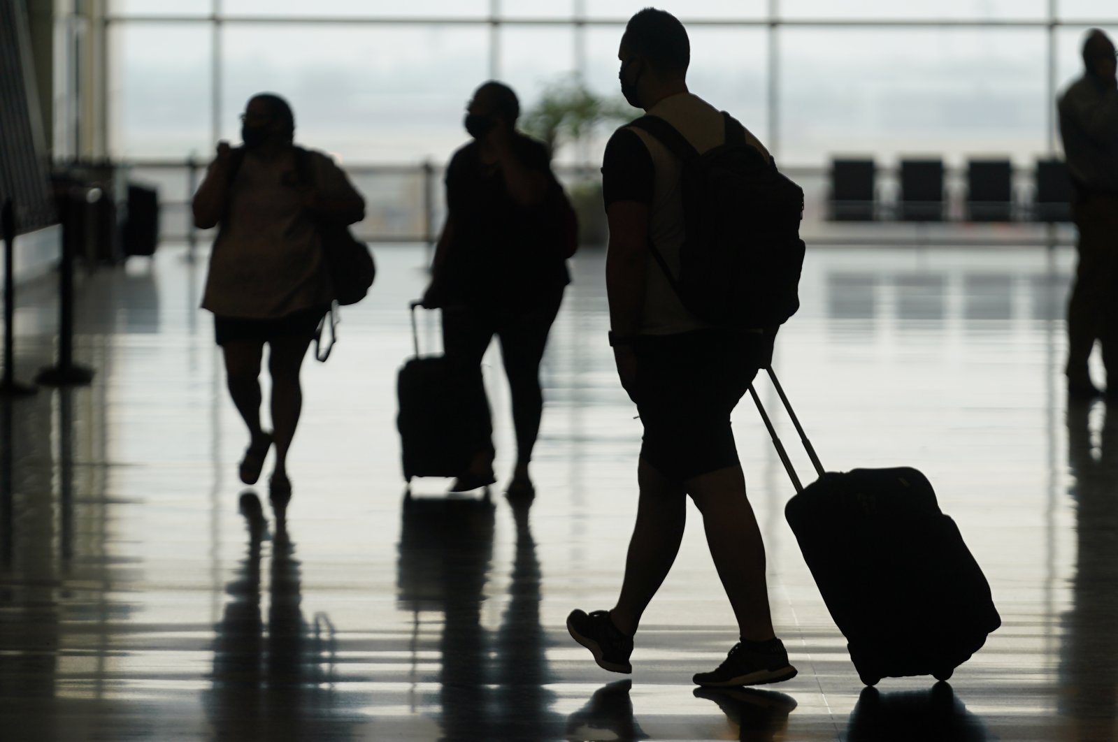 Travelers move through Salt Lake City International Airport, Salt Lake City, Utah, U.S., Aug. 17, 2021. (AP Photo)