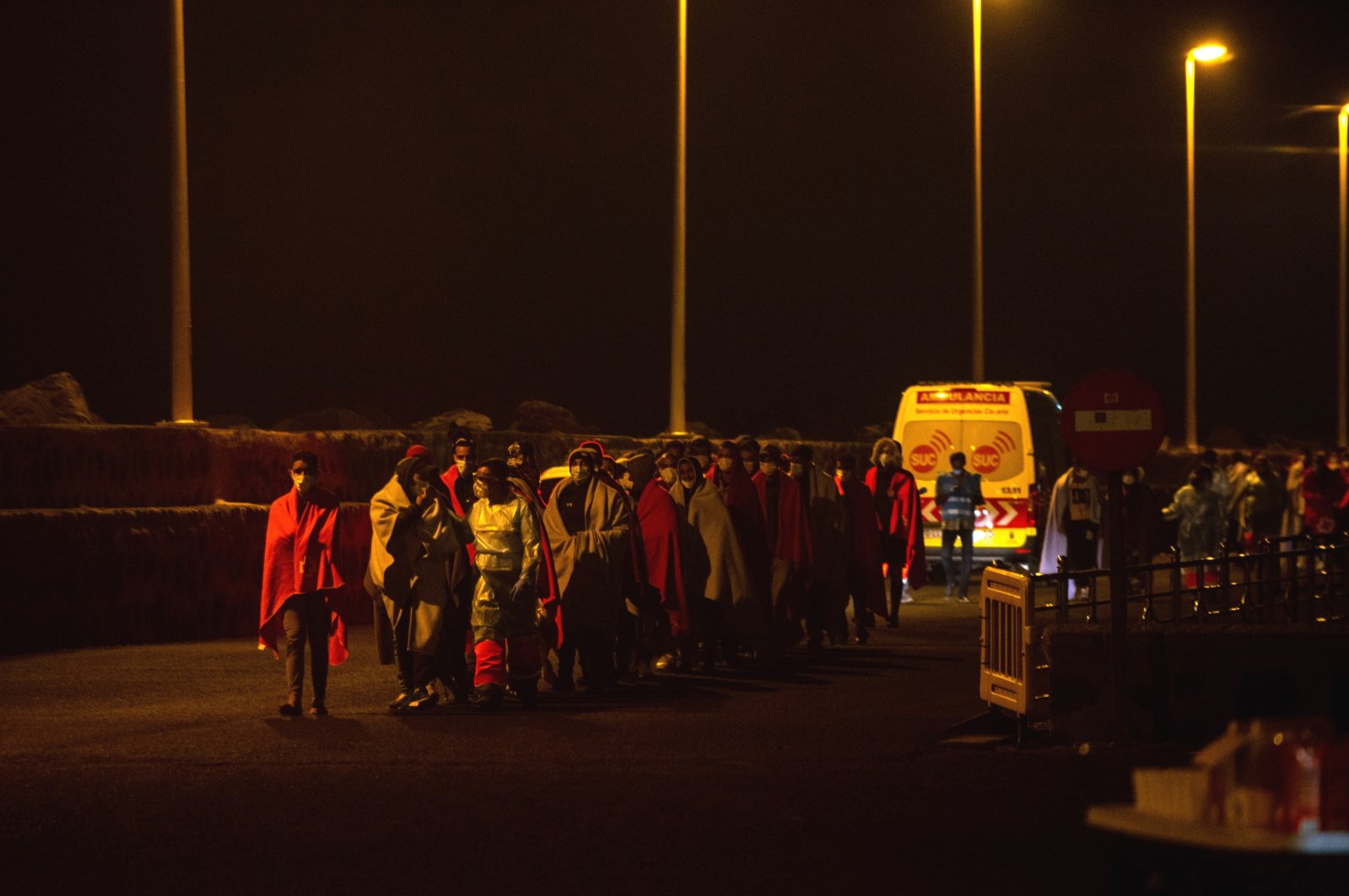 About 81 migrants, who traveled in two boats and who were rescued by Spanish Sea Rescue, arrive at Arrecifes port, in Lanzarote, Canary Islands, Nov. 22, 2021. (EPA/JAVIER FUENTES)