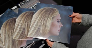 A member of staff sorts copies of the new album from British singer-songwriter Adele titled "30," in Sister Ray record store in Soho, central London, U.K., Nov. 19, 2021. (AFP)