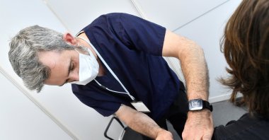 Nurse Stephen Connolly vaccinates health care worker Giovanni Franco with a Pfizer-BioNtech coronavirus vaccine booster at the University College Dublin (UCD) campus clinic for inoculating frontline workers in Dublin, Ireland, Nov. 28, 2021. (Reuters Photo)