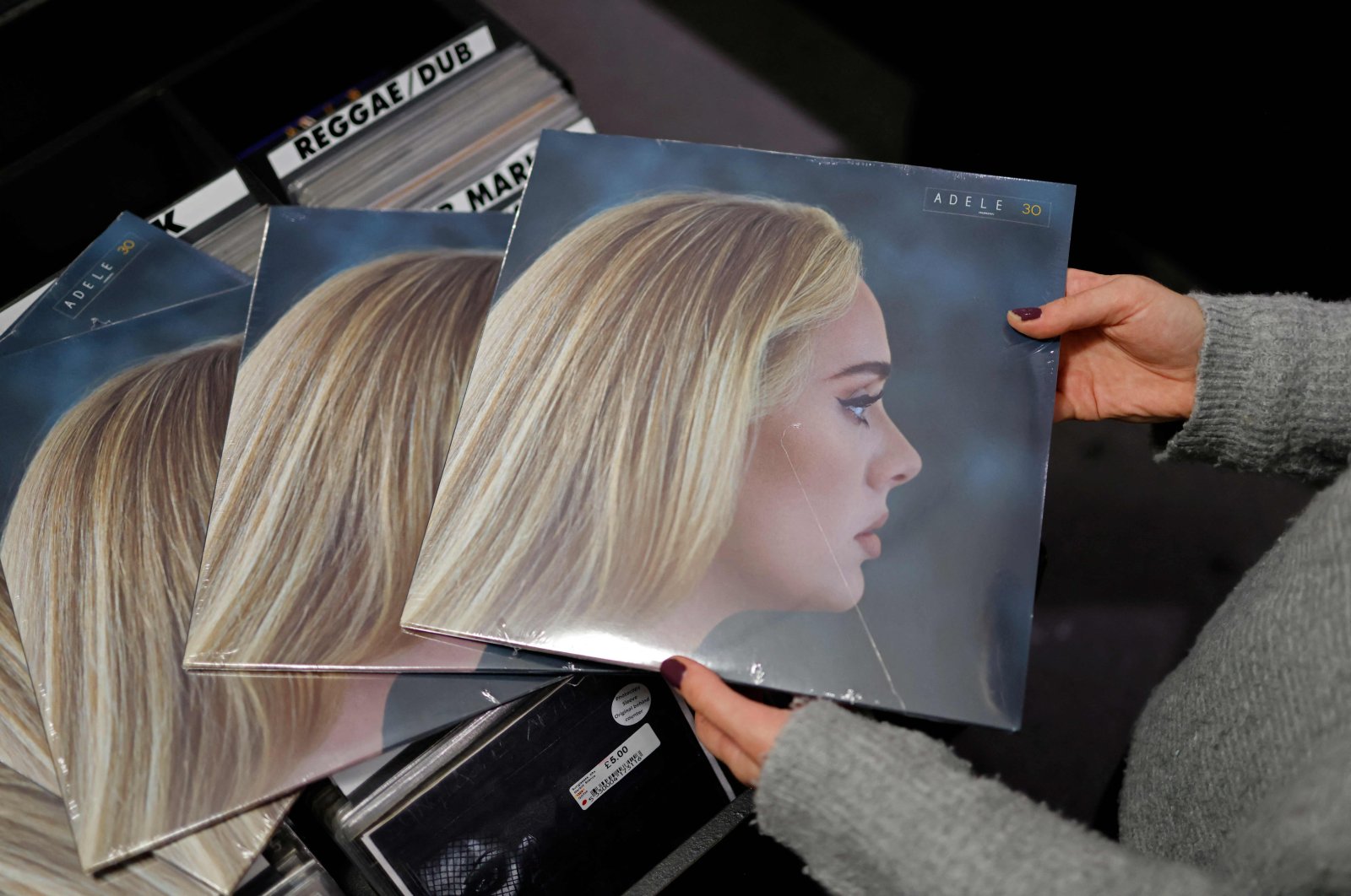 A member of staff sorts copies of the new album from British singer-songwriter Adele titled &quot;30,&quot; in Sister Ray record store in Soho, central London, U.K., Nov. 19, 2021. (AFP)