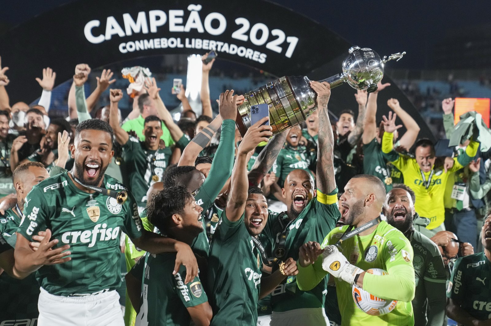 Palmeiras players celebrate with the trophy after beating Flamengo 2-1 in Copa Libertadores final Montevideo, Uruguay, Nov. 27, 2021. (AP Photo)