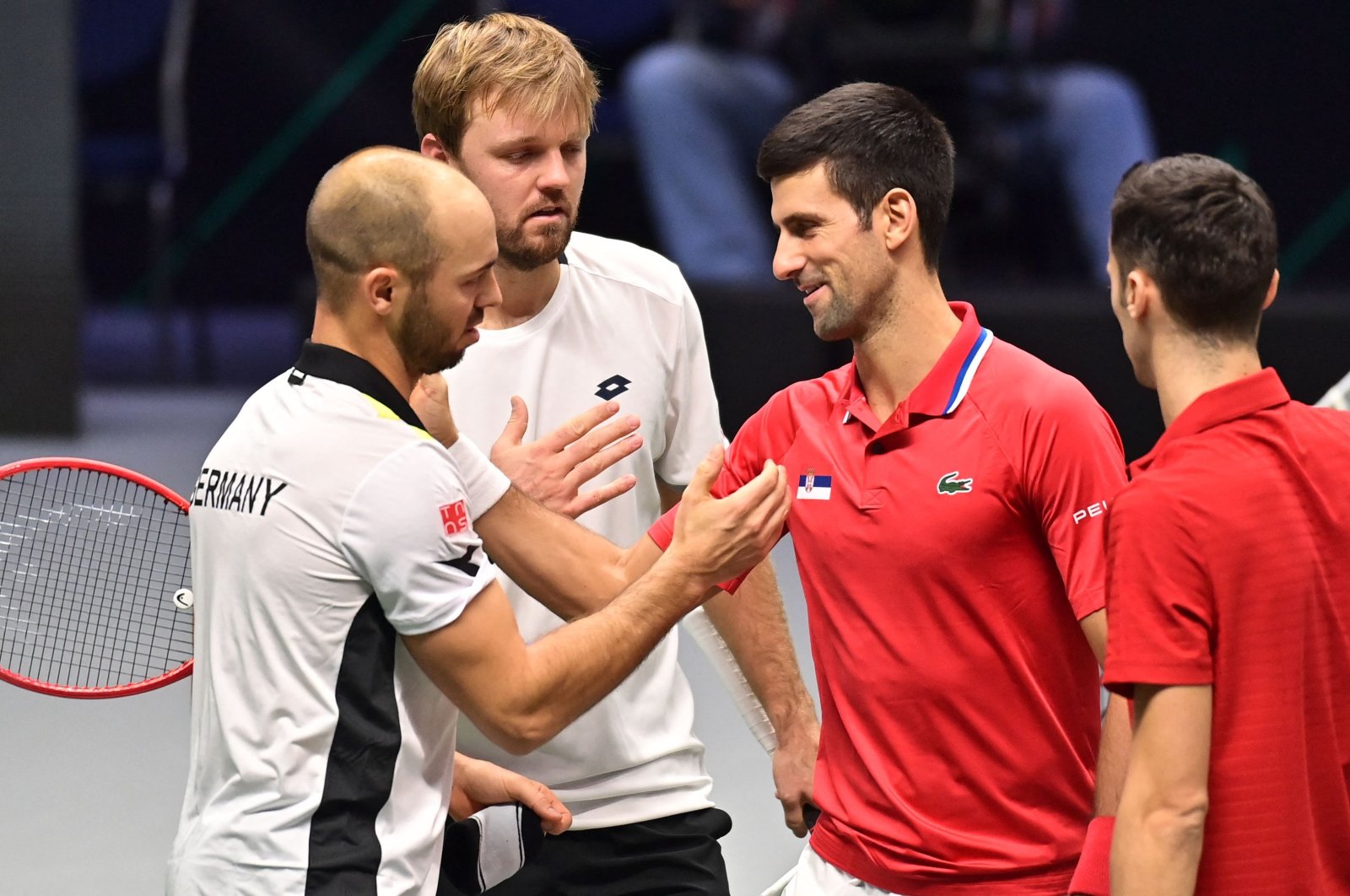 Germany&#039;s Kevin Krawietz (2nd L) and Tim Puetz (L) are congratulated by Serbia&#039;s Novak Djokovic (2nd R) and Nikola Cacic (R) at the end of the men&#039;s doubles group stage Davis Cup match, Innsbruck, Austria, Nov. 27, 2021. (AFP Photo)