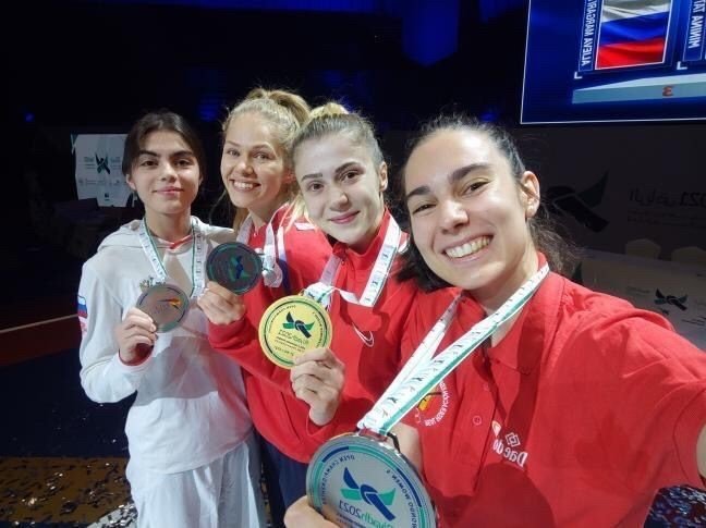 World Taekwondo Champion in the 53-kilogram category Mamak Municipality athlete Merve Dinçel (2-R) can be seen with her medal, Ankara, Turkey, Nov. 29, 2021. (IHA Photo)